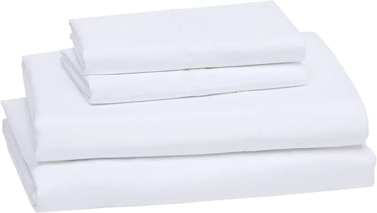Neat Valley folded white sheets and pillowcases stacked on a white background